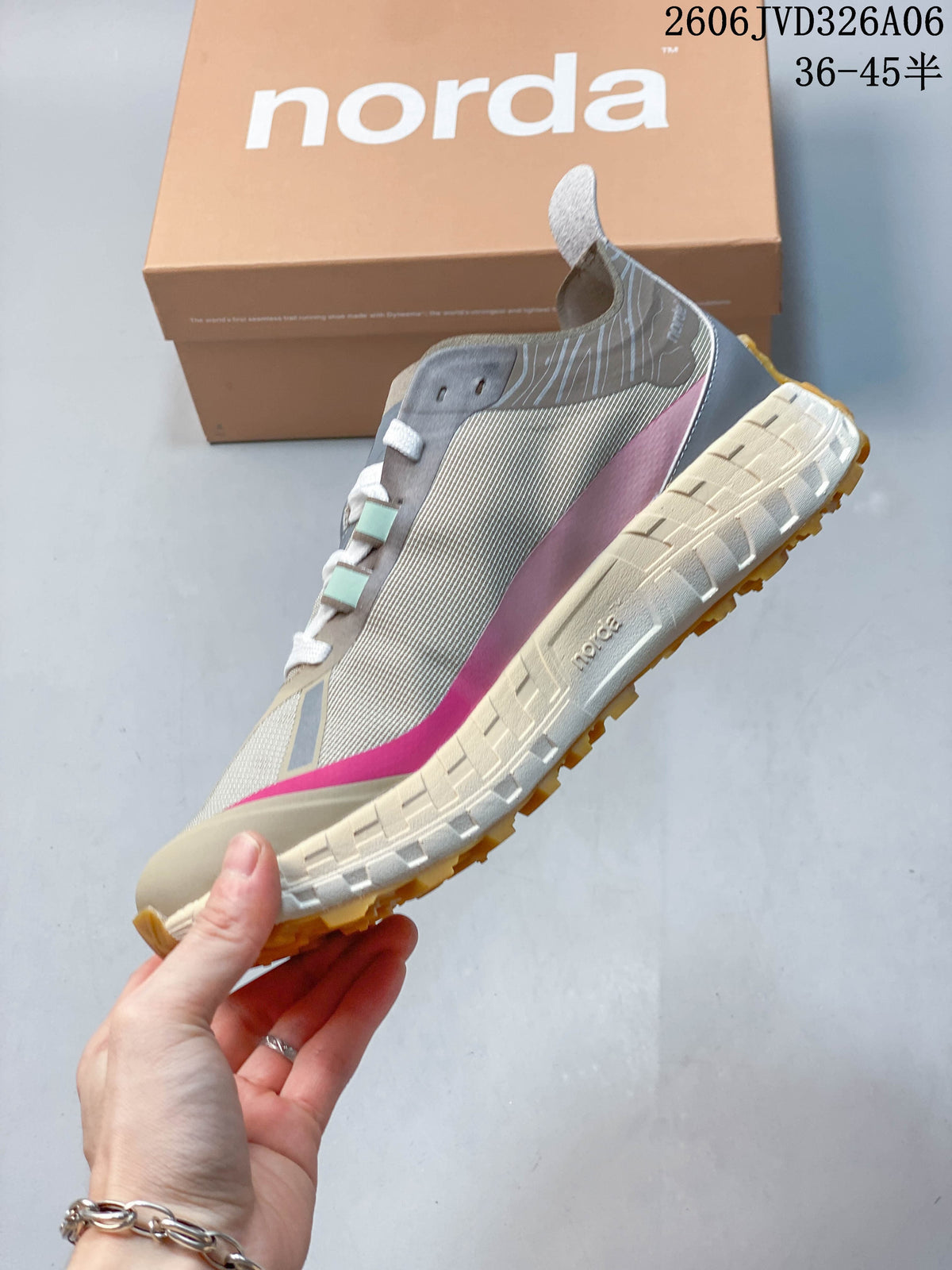 Side view of a taupe sneaker with pink side accents and a chunky lugged sole.