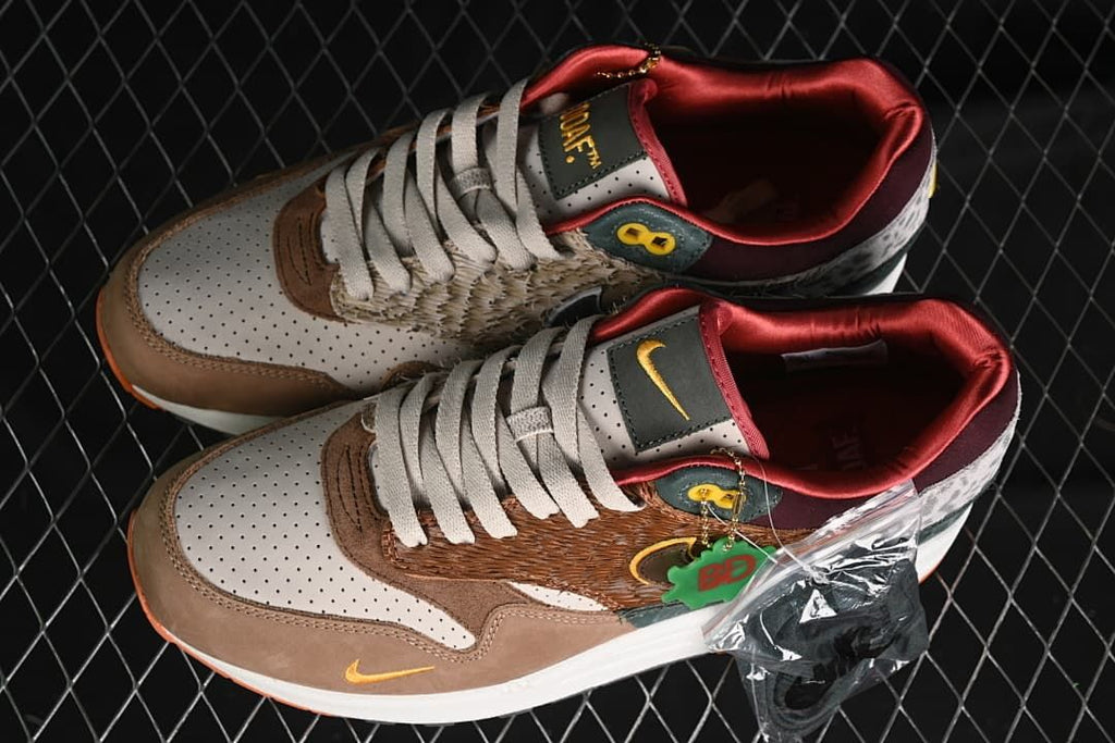 Pair of multicolor Air Max 1/87 sneakers with decorative hangtags.