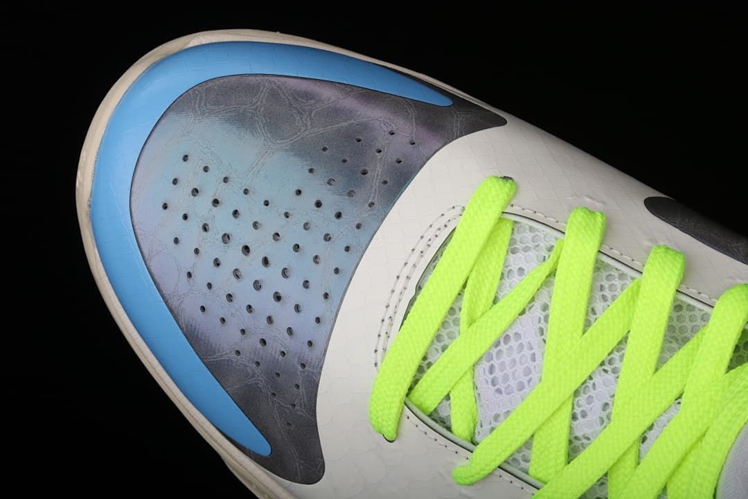 Close-up of the perforated grey toe panel and blue toe accent