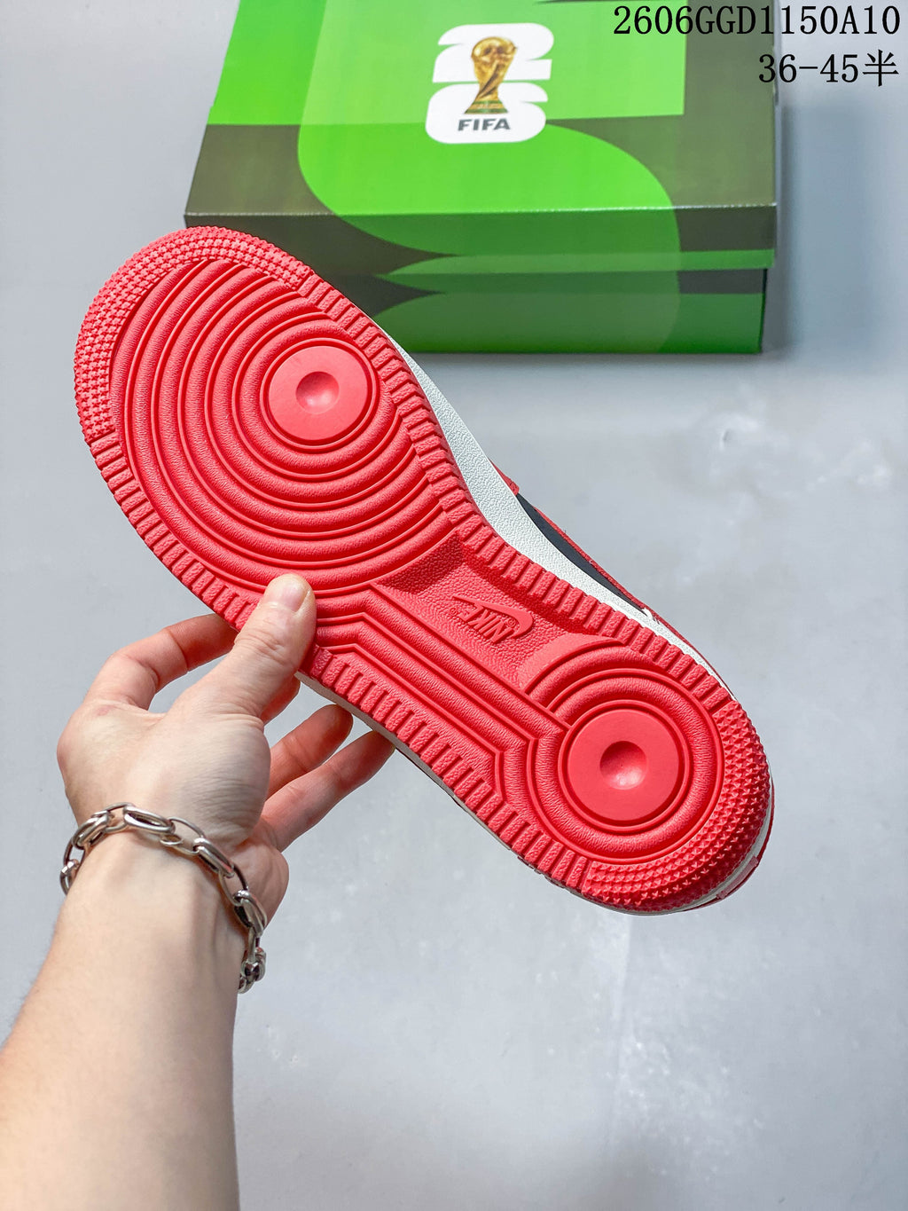 Close-up of the red rubber outsole with circular tread pattern.