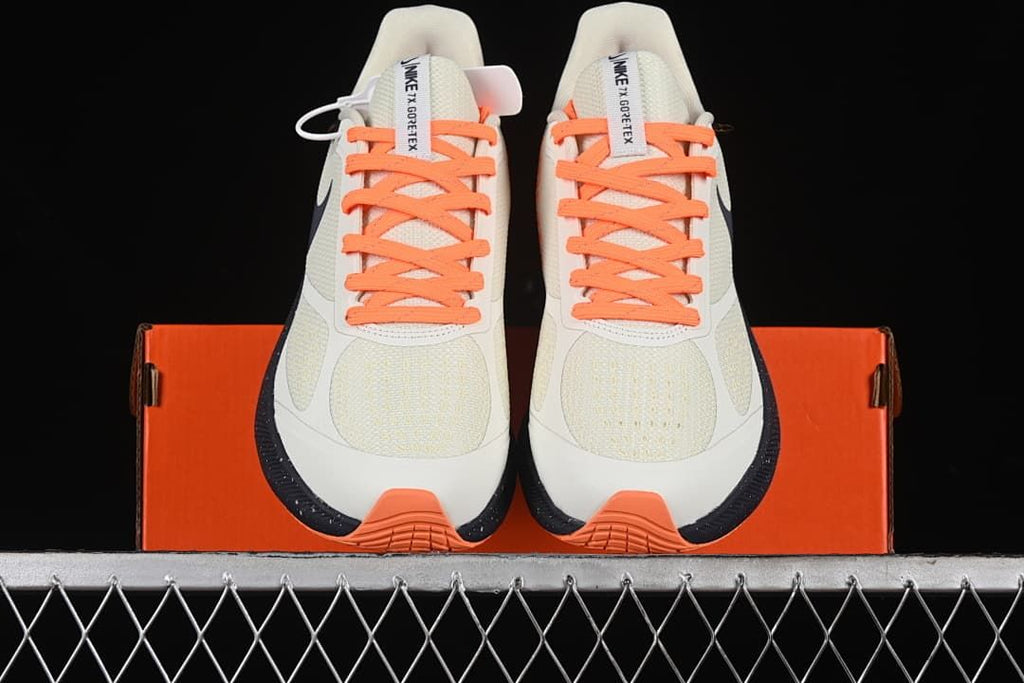 Front view of the pair with orange laces and toe accents