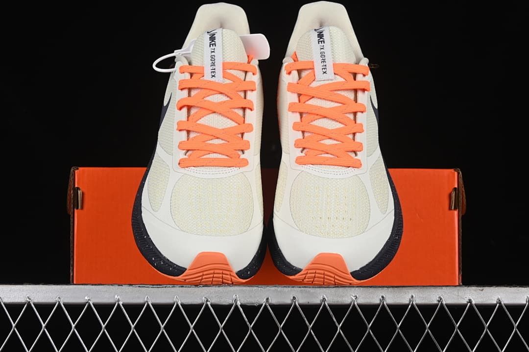 Front view of the pair with orange laces and toe accents