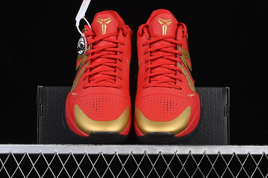 Front view of the shoes showing perforated toes and gold accents