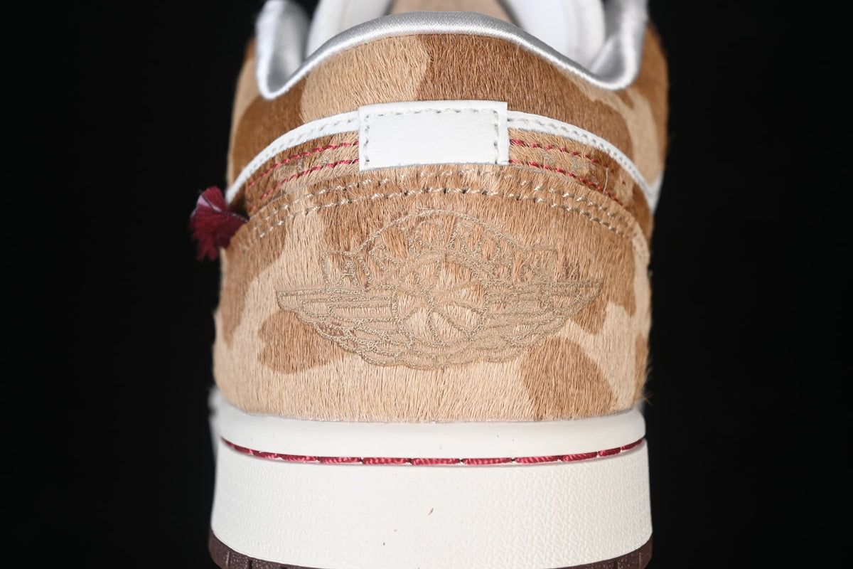 Rear close-up showing the tan patterned heel and embroidered detail