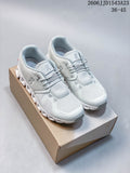 Pair of light-colored On Cloudtilt Remix sneakers on a shoebox