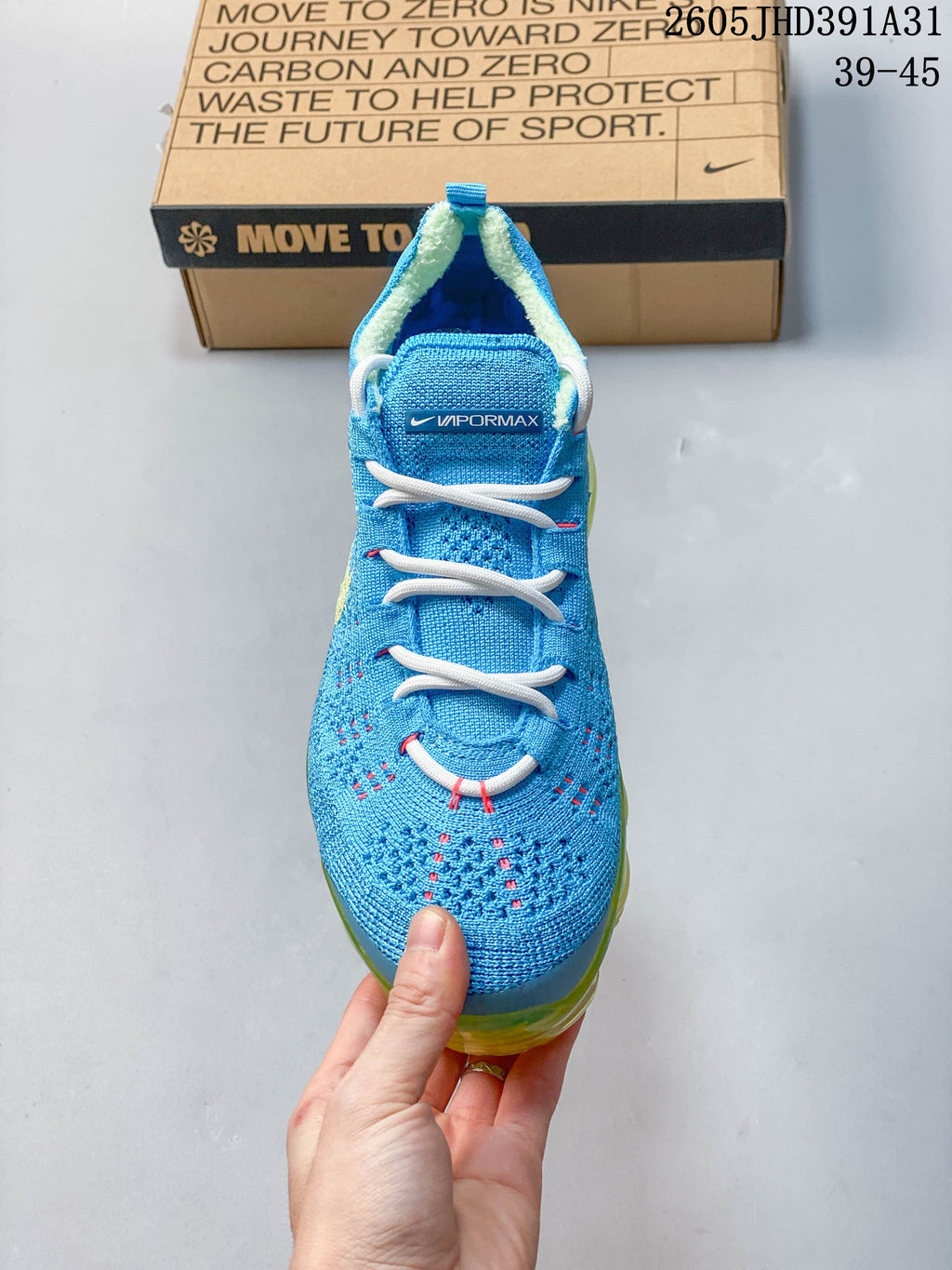 Front view of a blue shoe with white laces and pink lace details