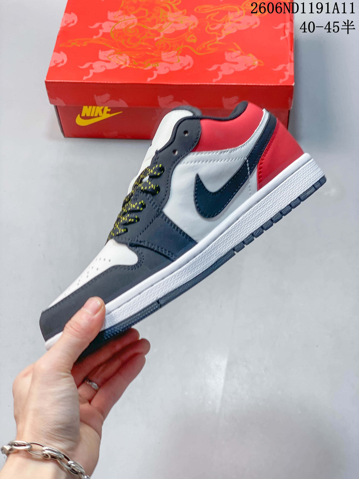Side view of a low-top sneaker with navy overlays, white panels, and a red heel