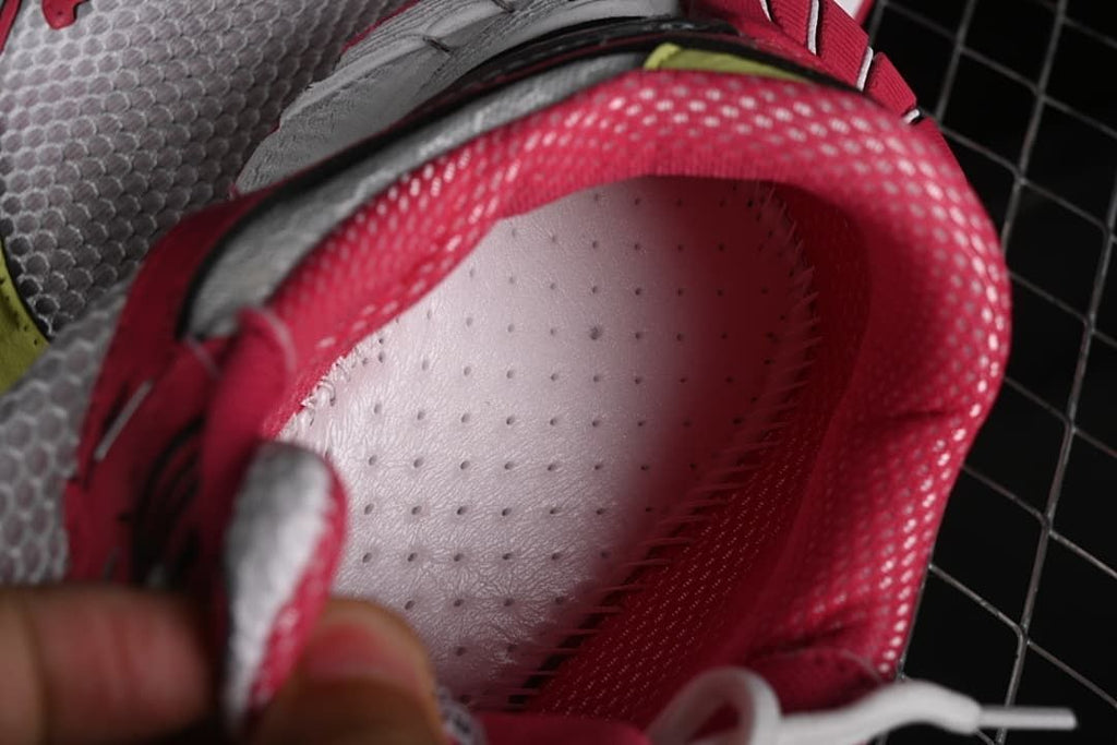 Close-up view inside the sneaker showing the padded pink collar and footbed