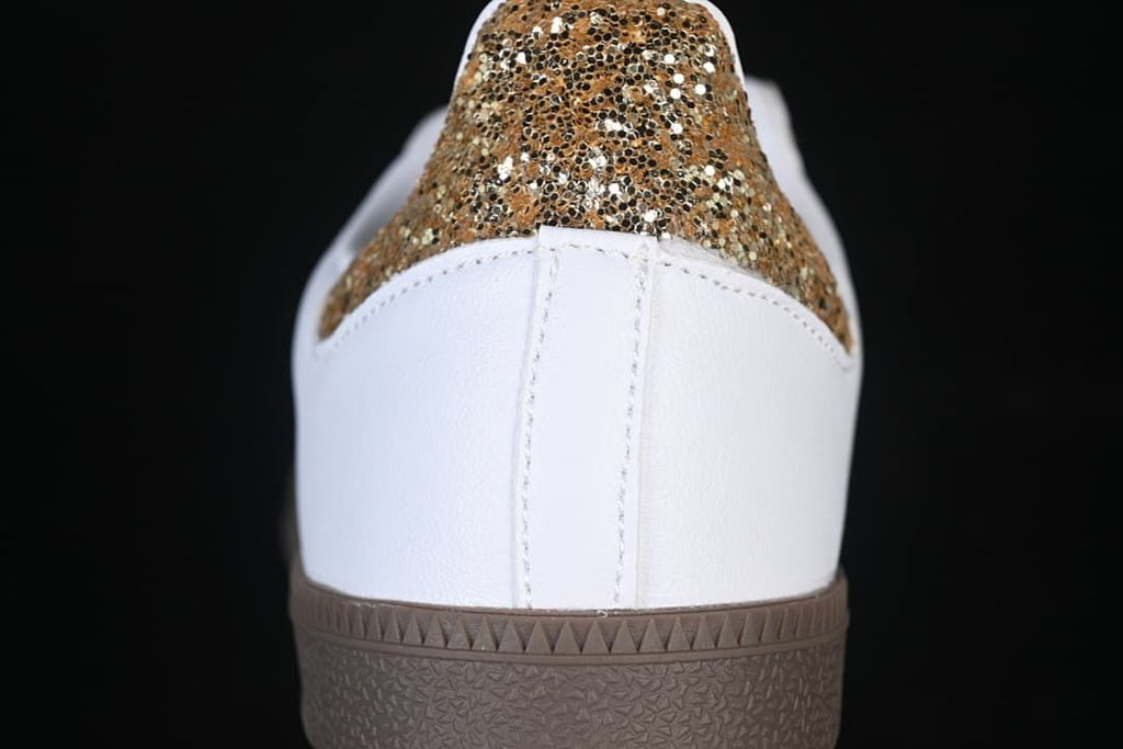 Rear close-up of the white heel and gold glitter-style heel panel