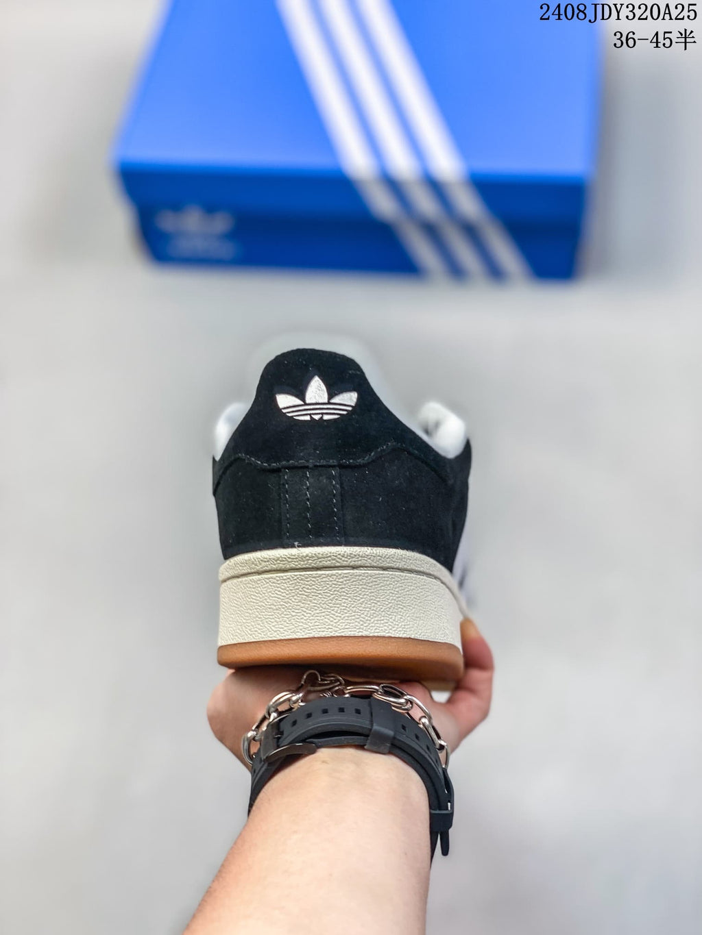 Rear view showing the black heel panel, trefoil mark, off-white midsole, and gum outsole.
