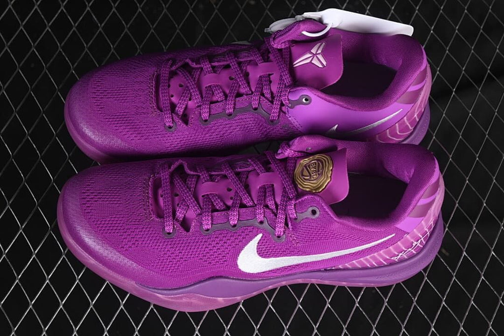 Pair of purple basketball shoes viewed from above and the side