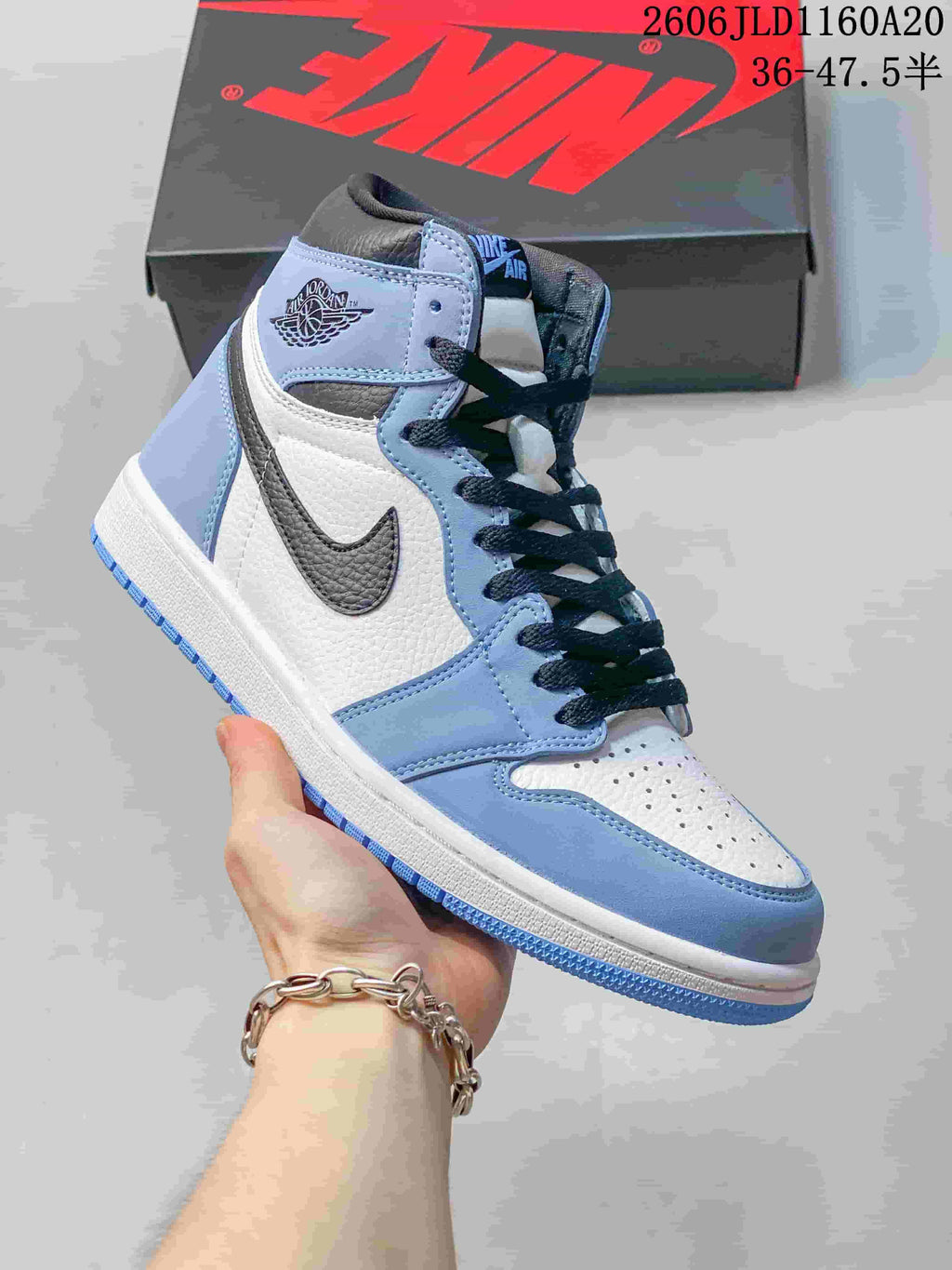 Side view of a white and light blue Jordan 1 high-top sneaker
