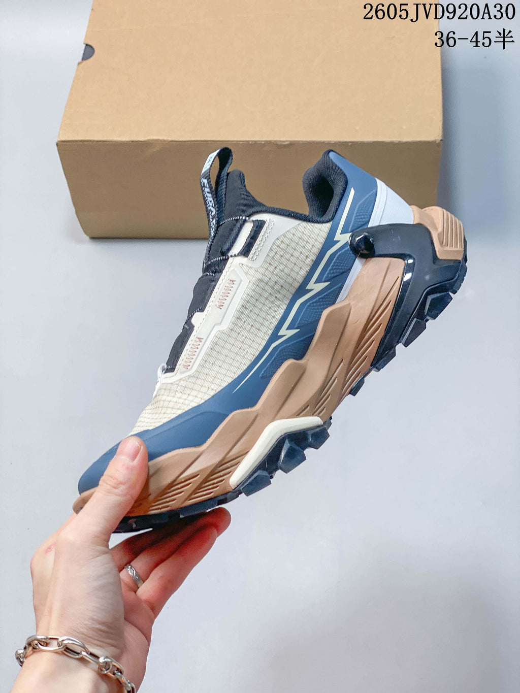 Side view of the Kailas trail shoe with its layered sole and blue accents