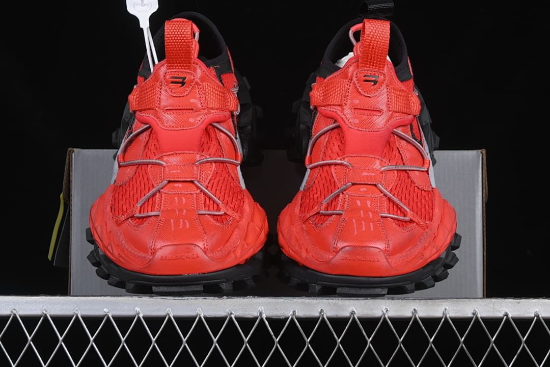 Front view of the pair showing the red uppers and rugged black outsole