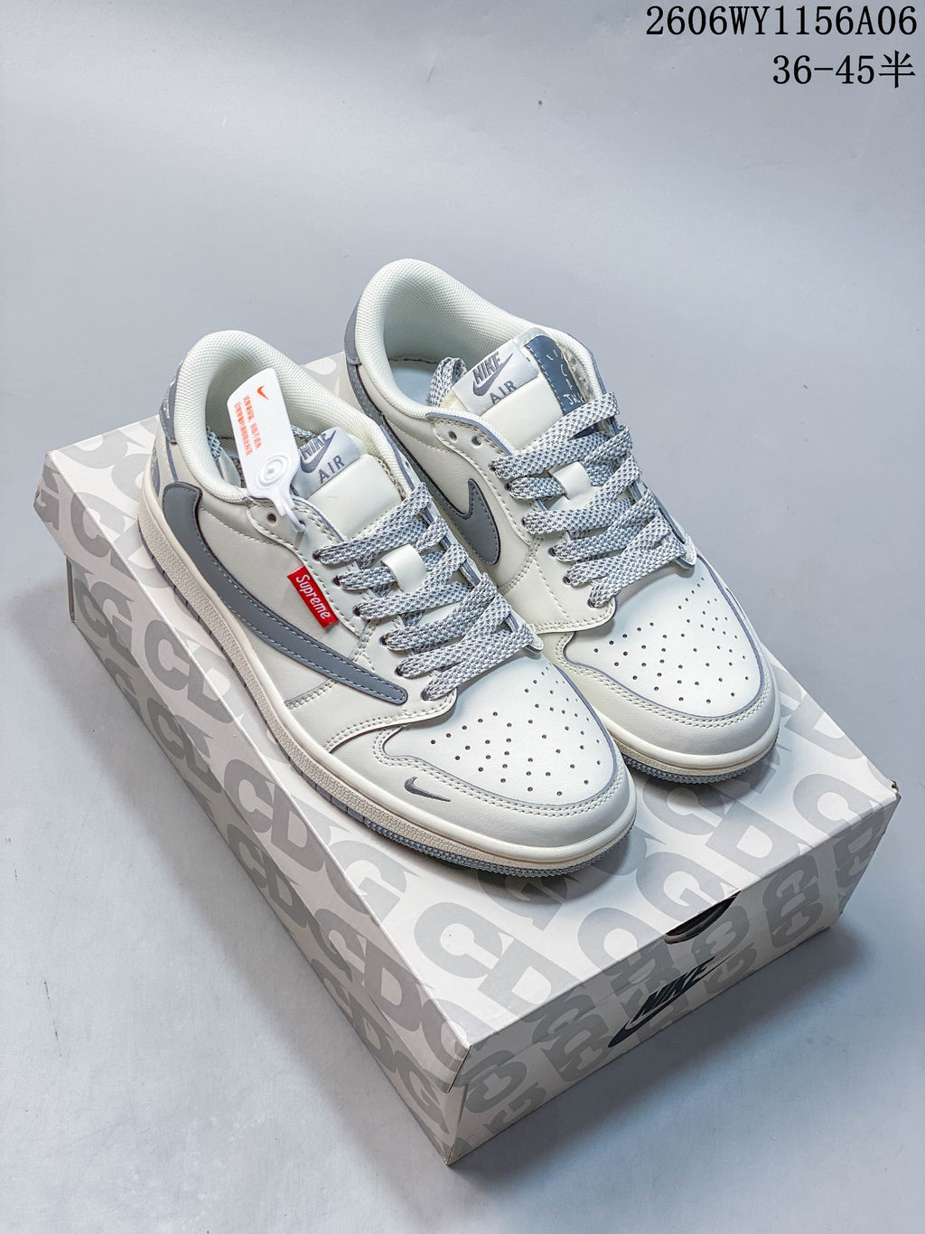 Pair of white and gray low-top sneakers with gray side panels and patterned laces