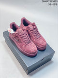 Pair of dusty rose Nike Air Force 1 low-top sneakers displayed on a shoebox