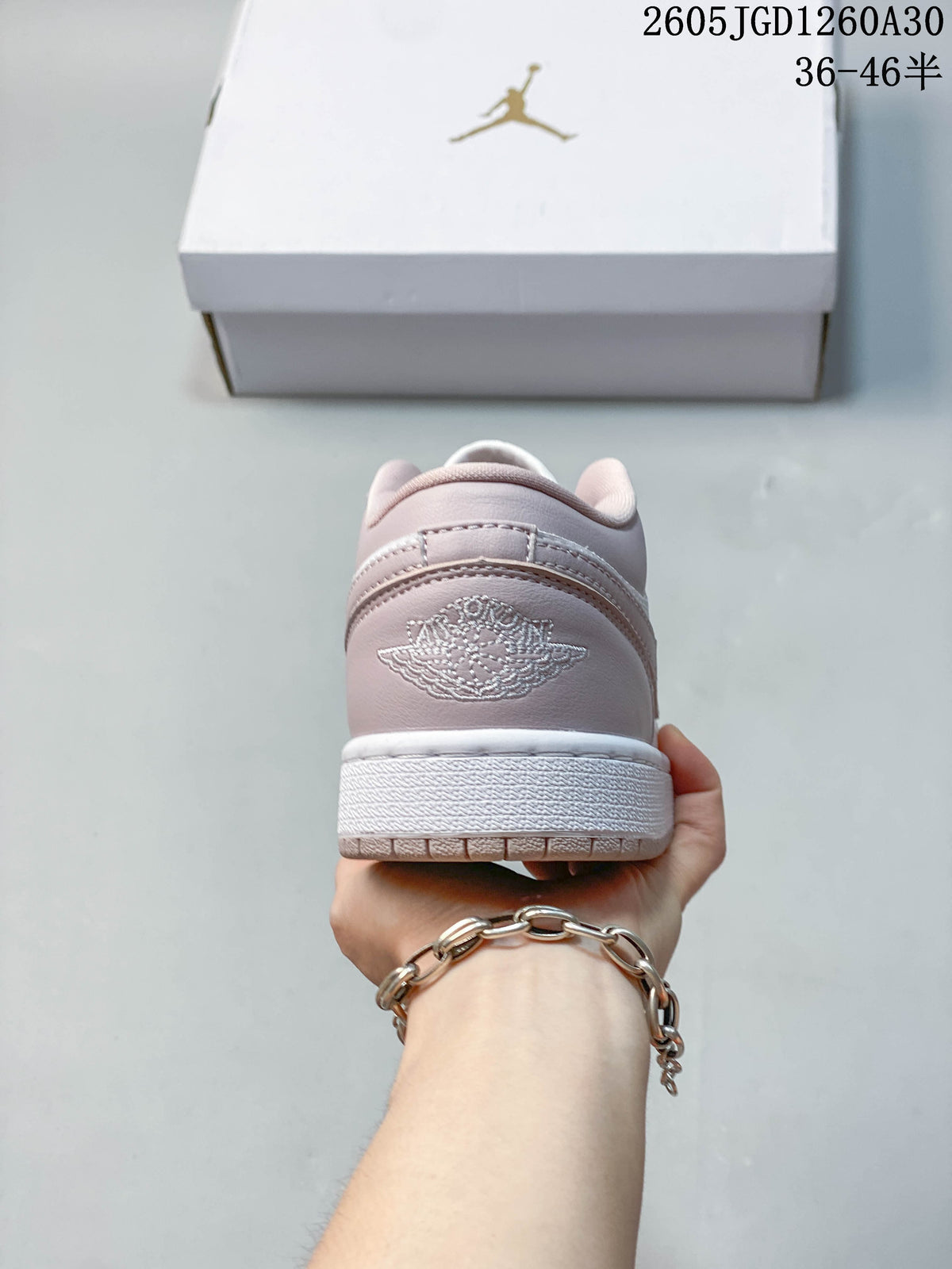 Rear view showing the blush-pink heel and embroidered logo