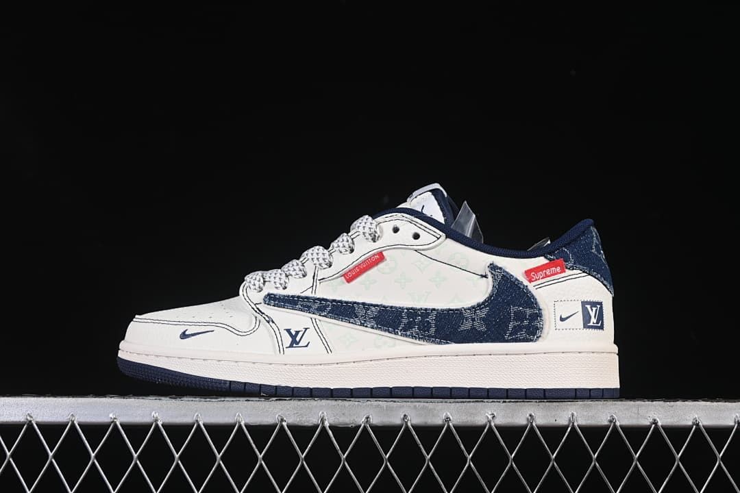 Side view of a white and navy low-top sneaker with denim-look Swoosh panels and graphic accents