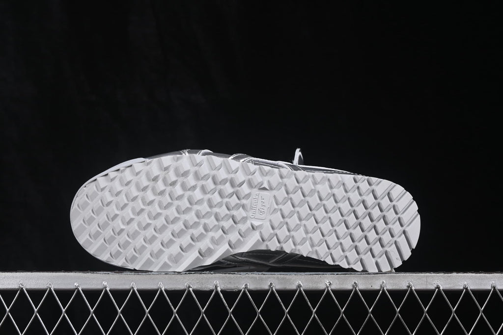 Underside view showing the white outsole with a repeating textured tread pattern.