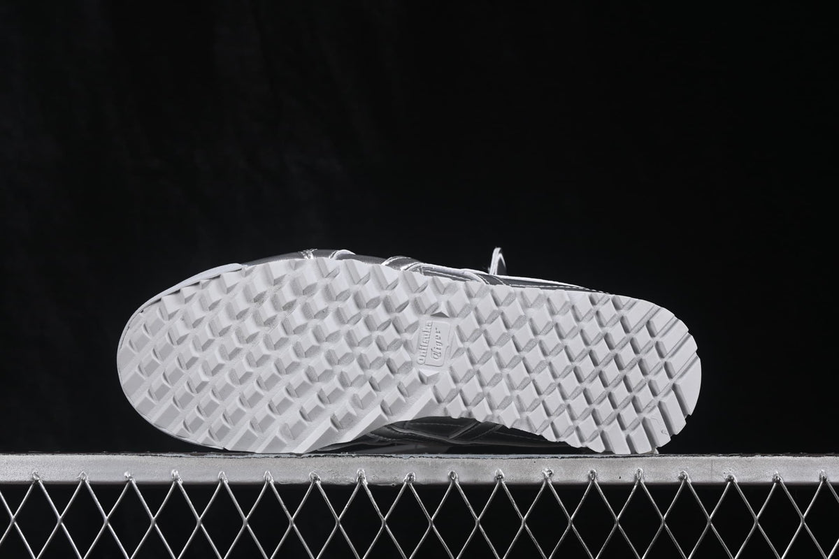 Underside view showing the white outsole with a repeating textured tread pattern.