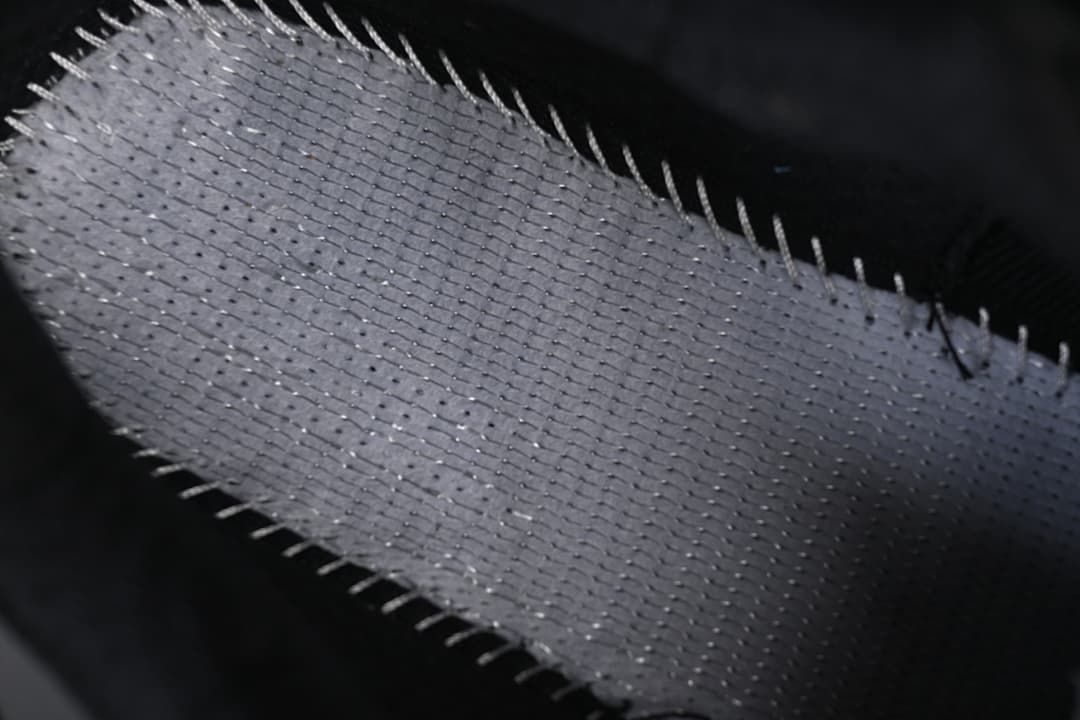 Macro view of textured sneaker fabric and stitching.