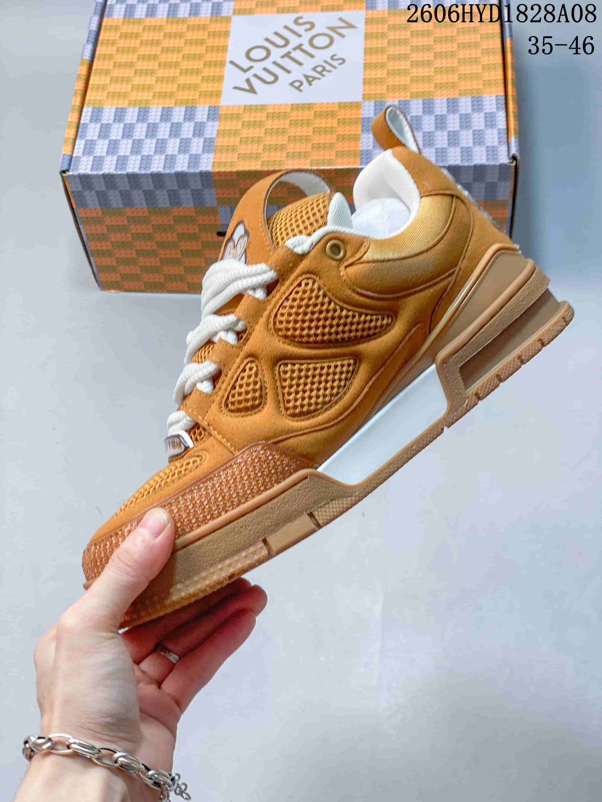 Side view of the brown mesh-panel sneaker with a white side accent