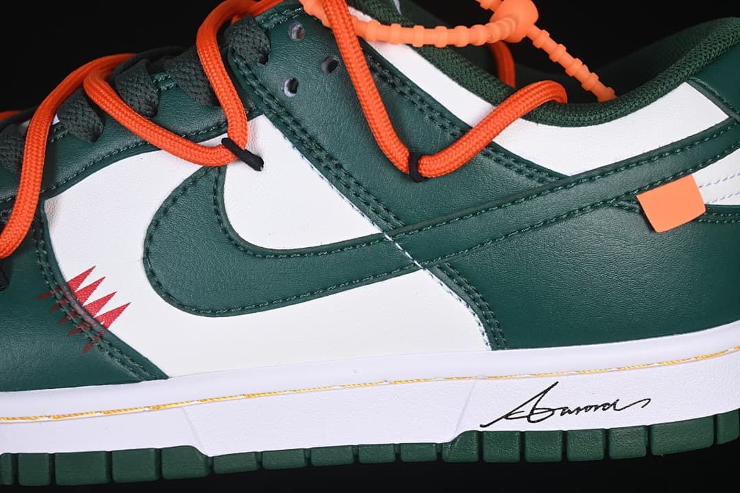 Close-up of green Swoosh, white side panel and orange laces