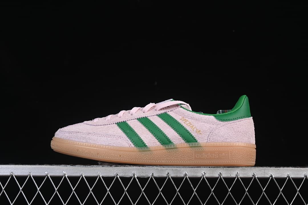 Side view of the pink and green sneaker against a dark background