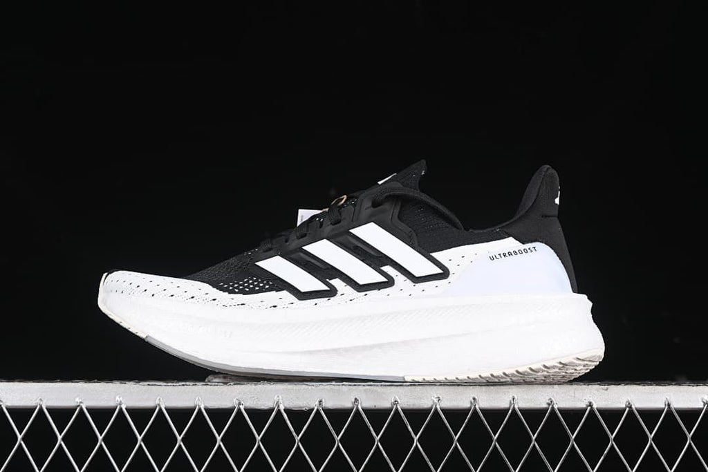 Side view of the black and white Adidas Ultraboost 5 shoe