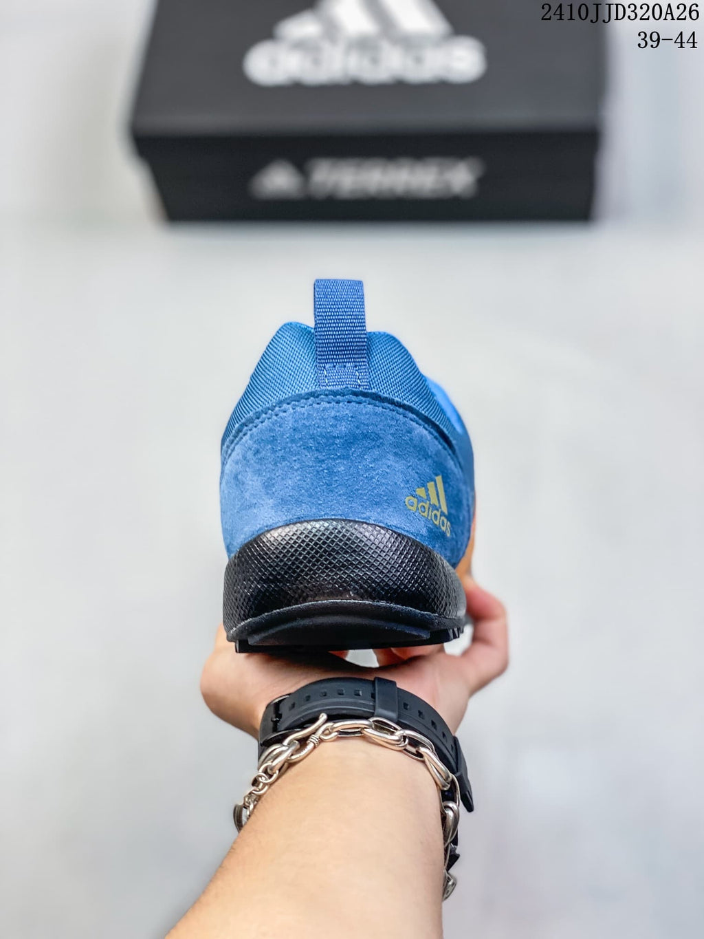 Rear view of the blue adidas shoe showing its heel pull tab and sole