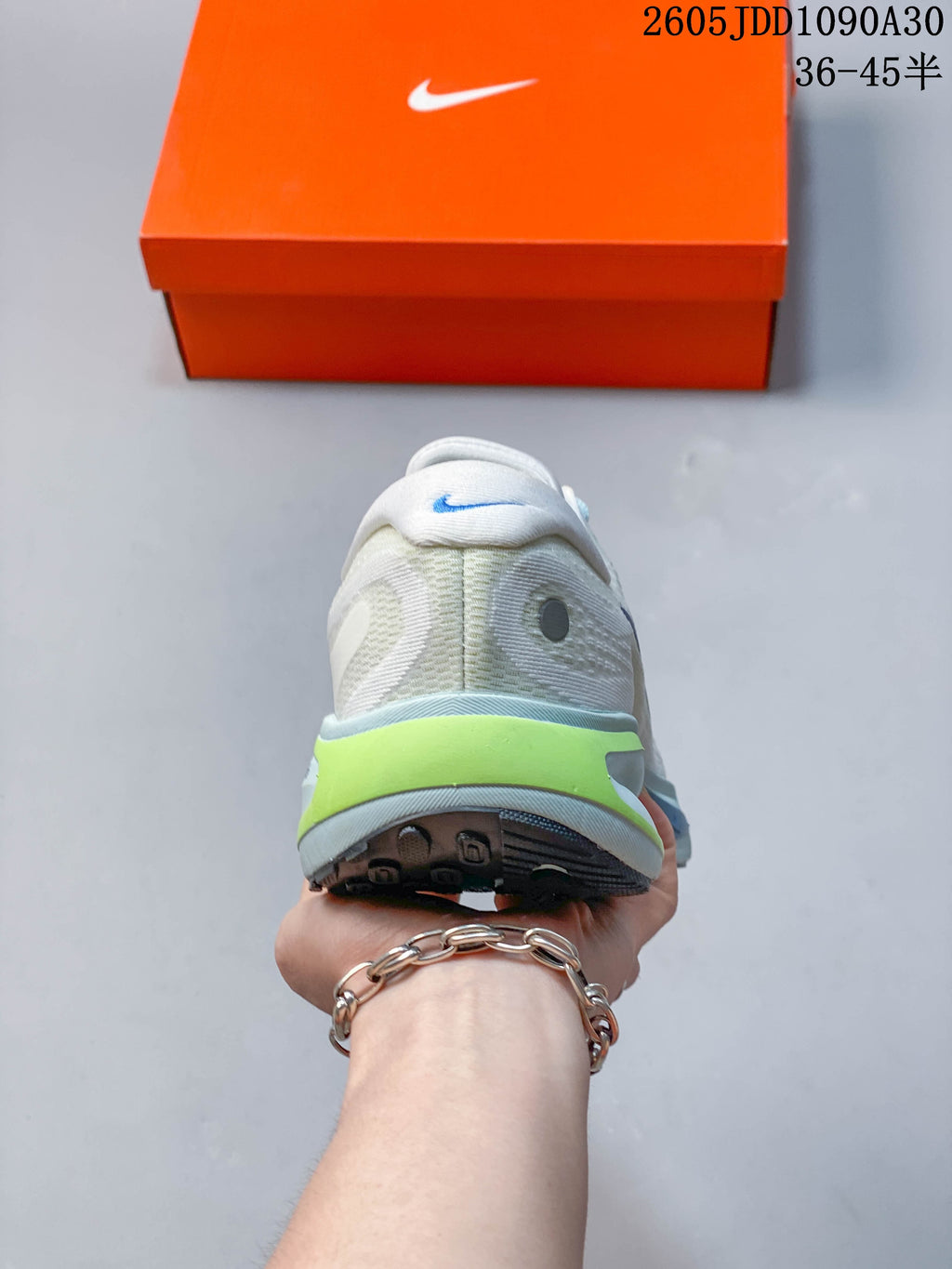 Rear view of the Nike Journey Run shoe showing its padded heel and lime accent.