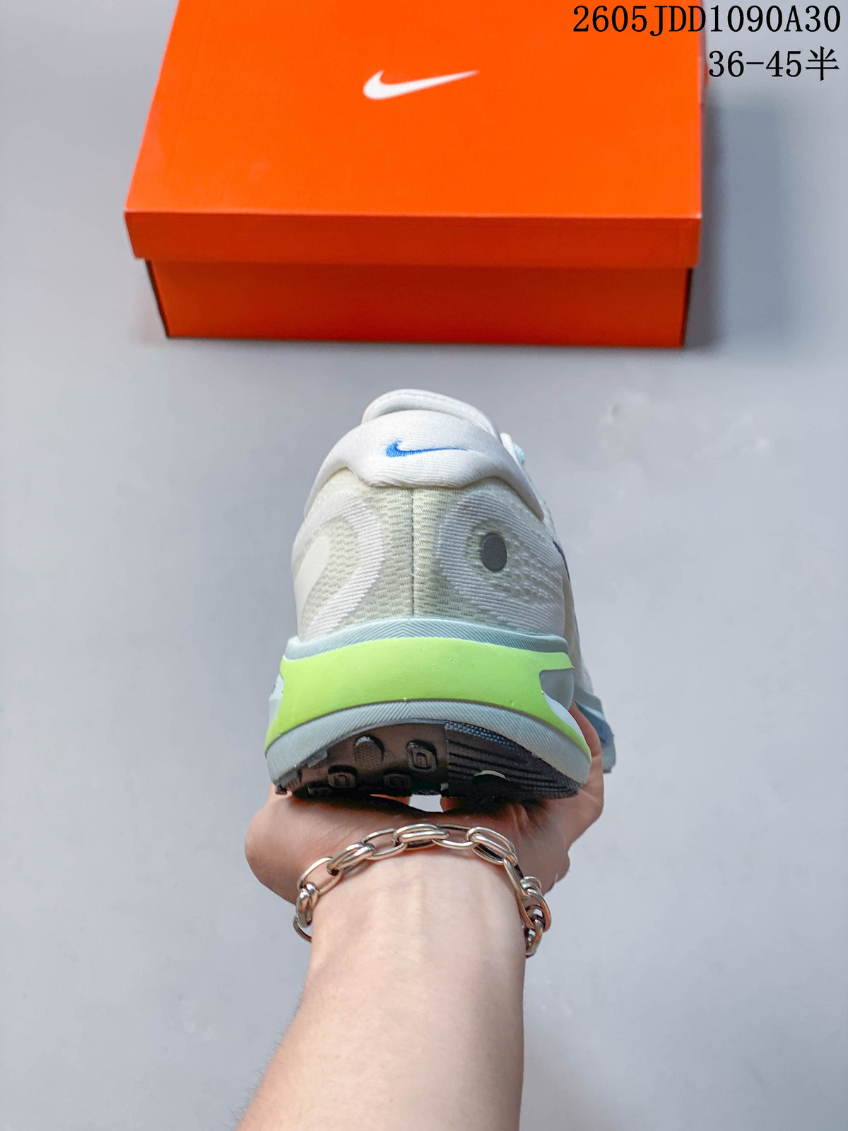 Rear view of the Nike Journey Run shoe showing its padded heel and lime accent.
