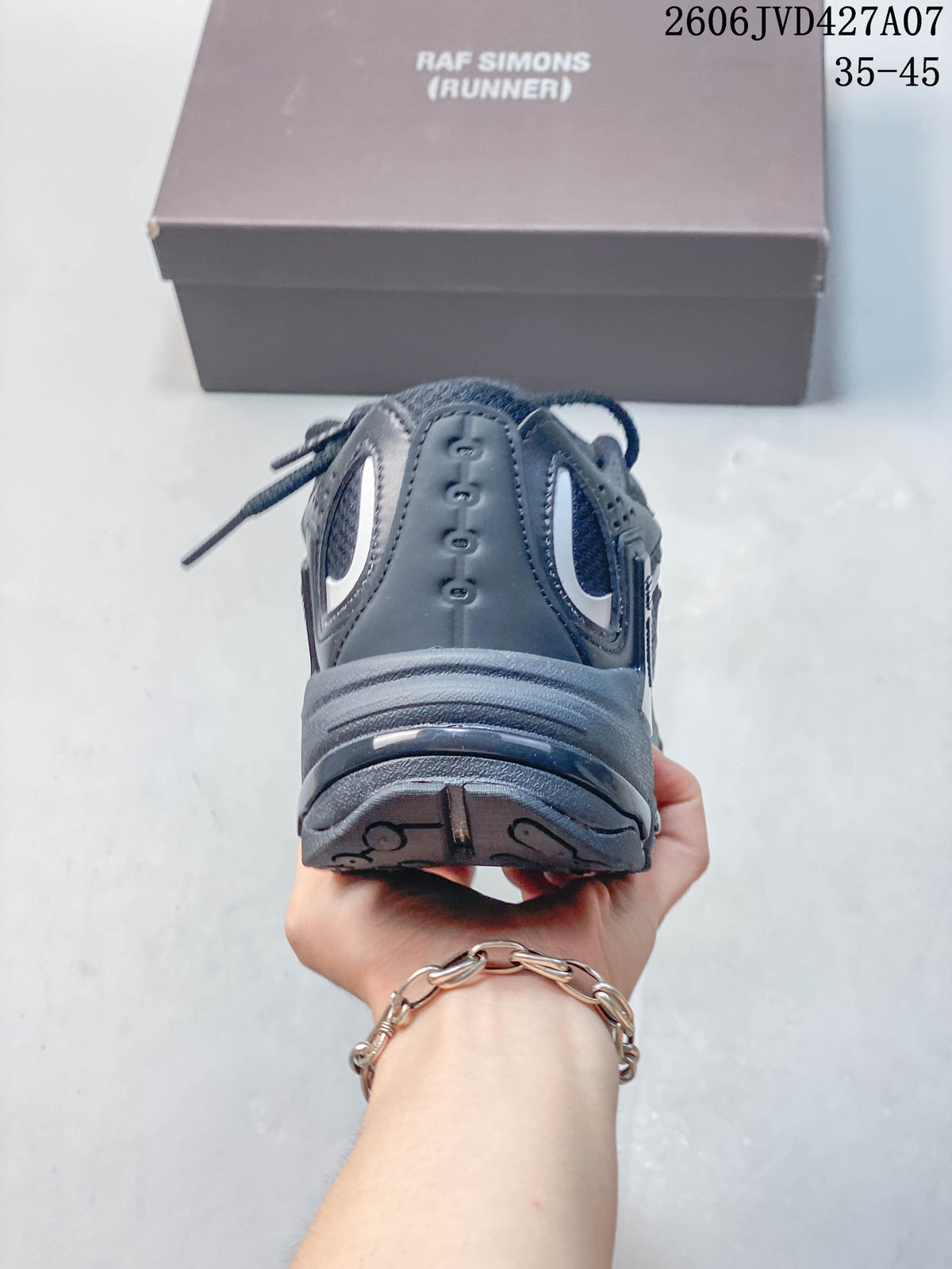 Rear view of a charcoal Raf Simons sneaker with a sculpted heel