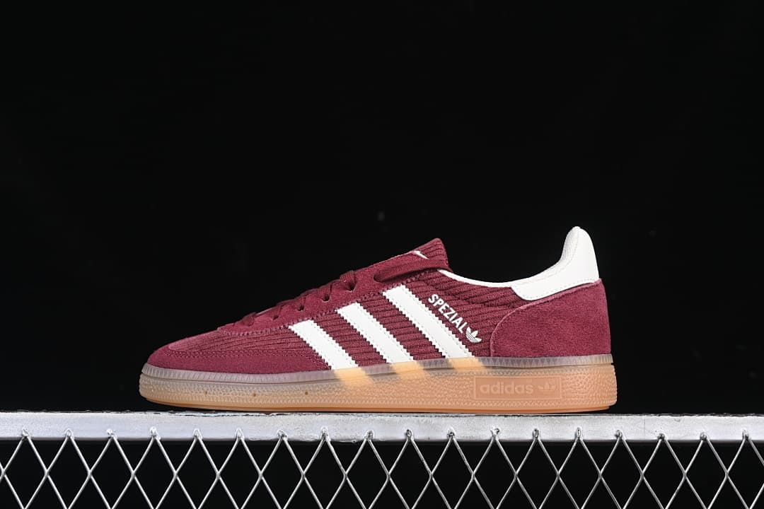 Side profile of a burgundy adidas Handball Spezial sneaker with white stripes and a gum-colored sole