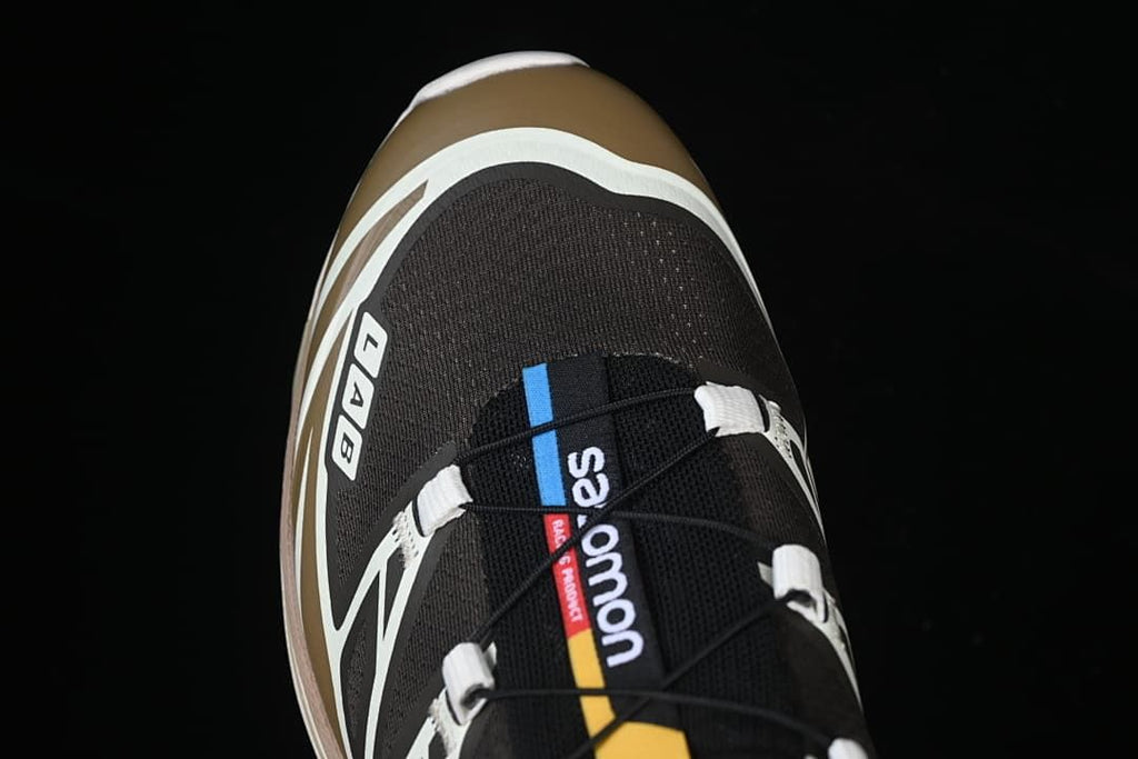 Top-down close-up of the shoe's tongue, quick-lace cord, and toe area.