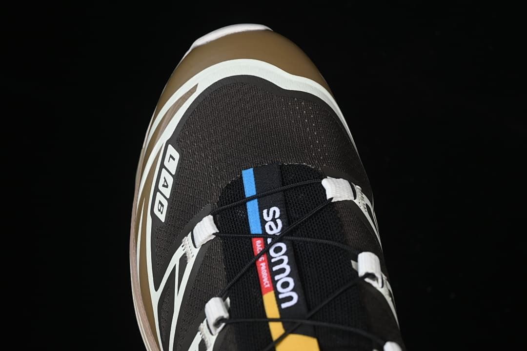 Top-down close-up of the shoe's tongue, quick-lace cord, and toe area.