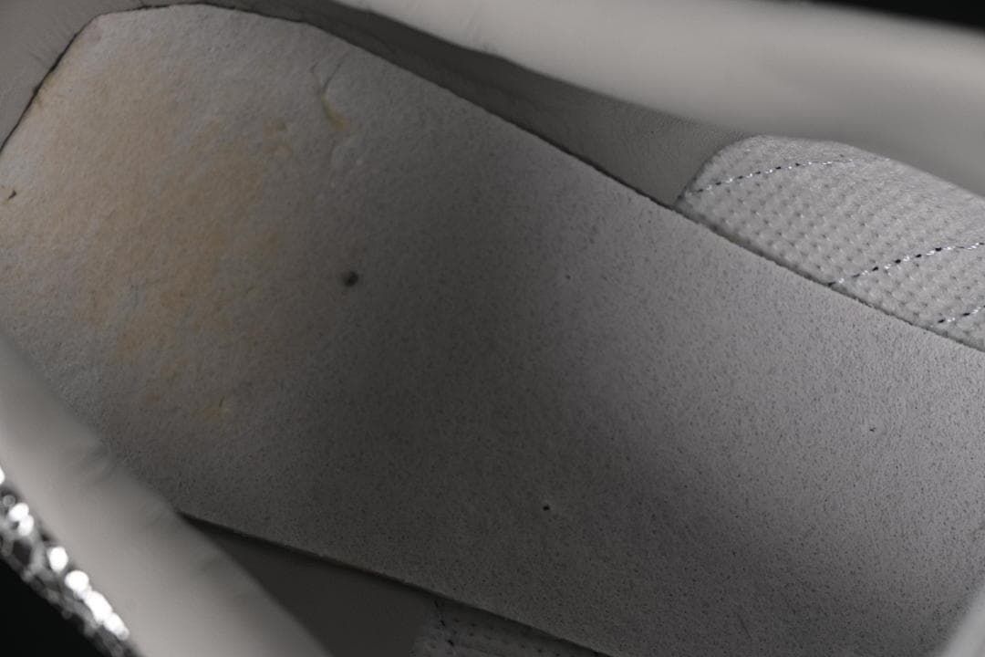 Close-up of the light-colored interior lining and stitching.