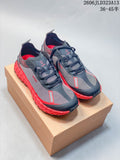 Pair of charcoal and red Norda 001 trail-running shoes on a box