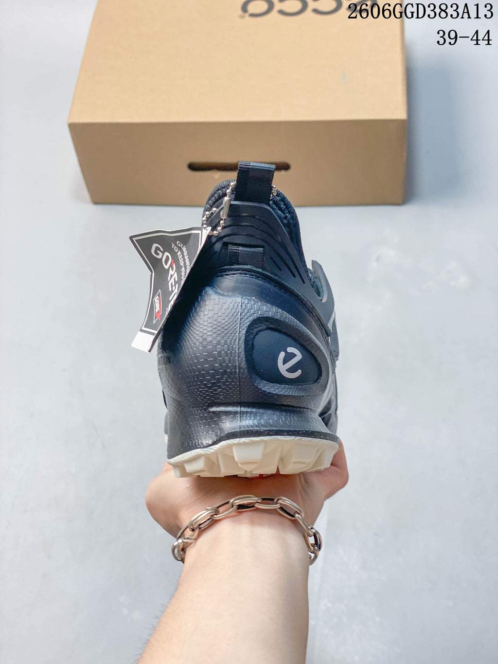 Rear view showing the sneaker's heel, pull tab, and rugged outsole.