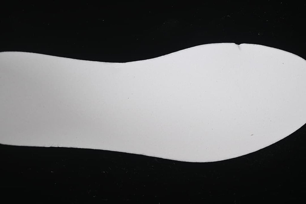Plain white shoe-shaped insert shown against a black background