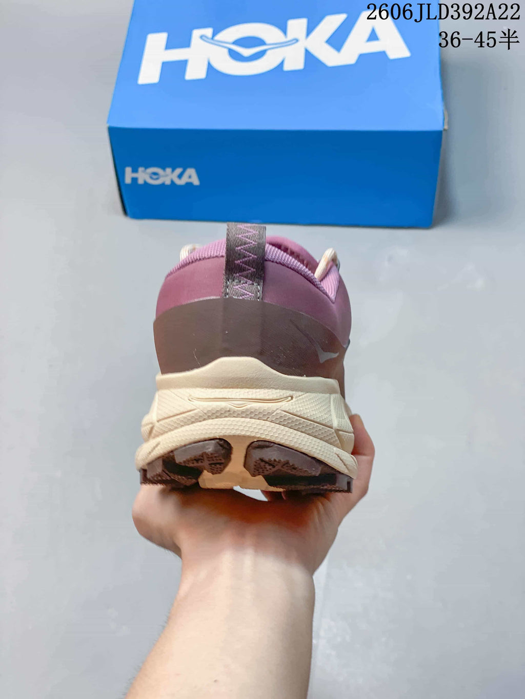 Rear view of a plum HOKA Tor Summit sneaker showing the heel and cream-colored sole.