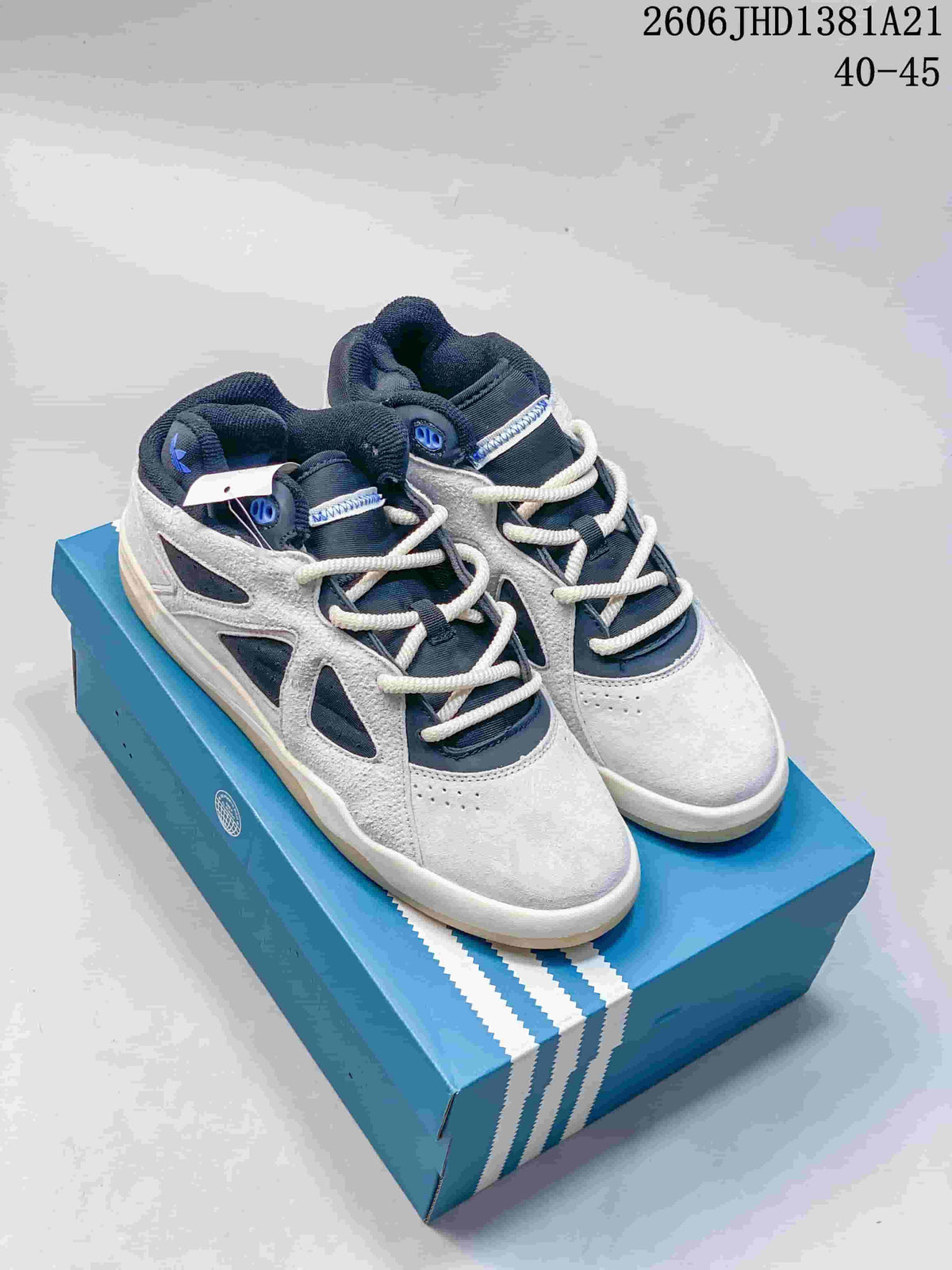 Pair of grey and navy adidas Bad Bunny Badbo 1.0 high-top sneakers on a blue box