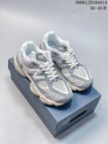 Pair of grey, white, and pale lavender New Balance 9060 sneakers on a shoebox