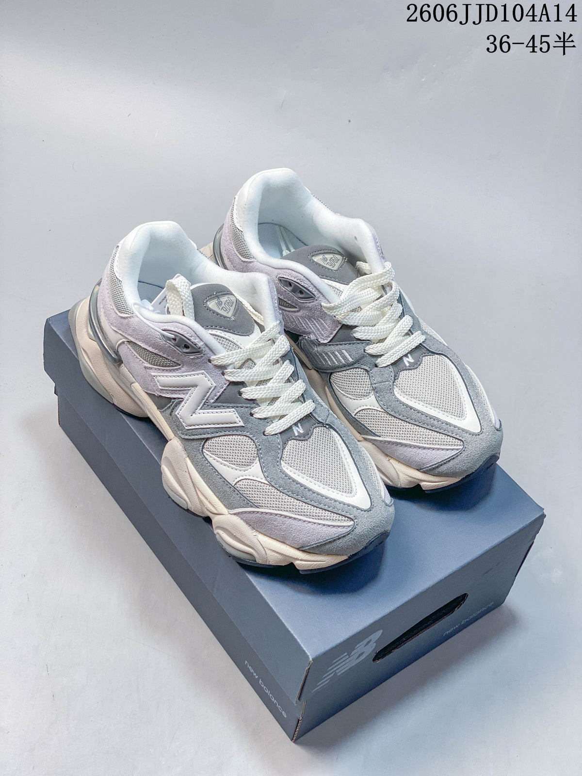 Pair of grey, white, and pale lavender New Balance 9060 sneakers on a shoebox