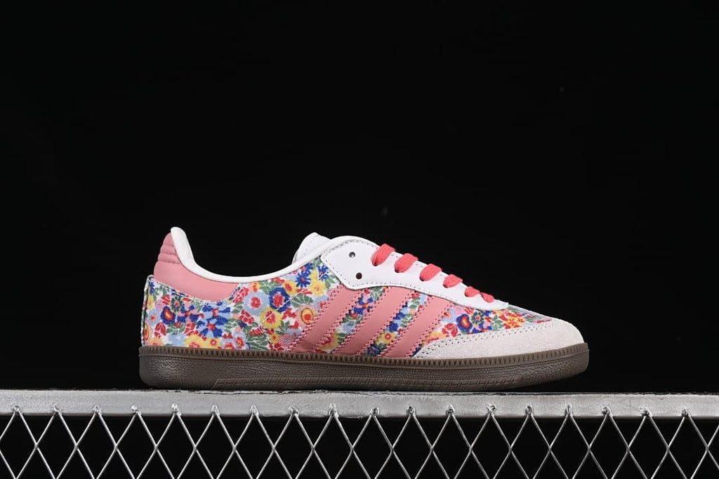 Side profile showing floral print, pink stripes, light-colored toe overlay, and brown sole