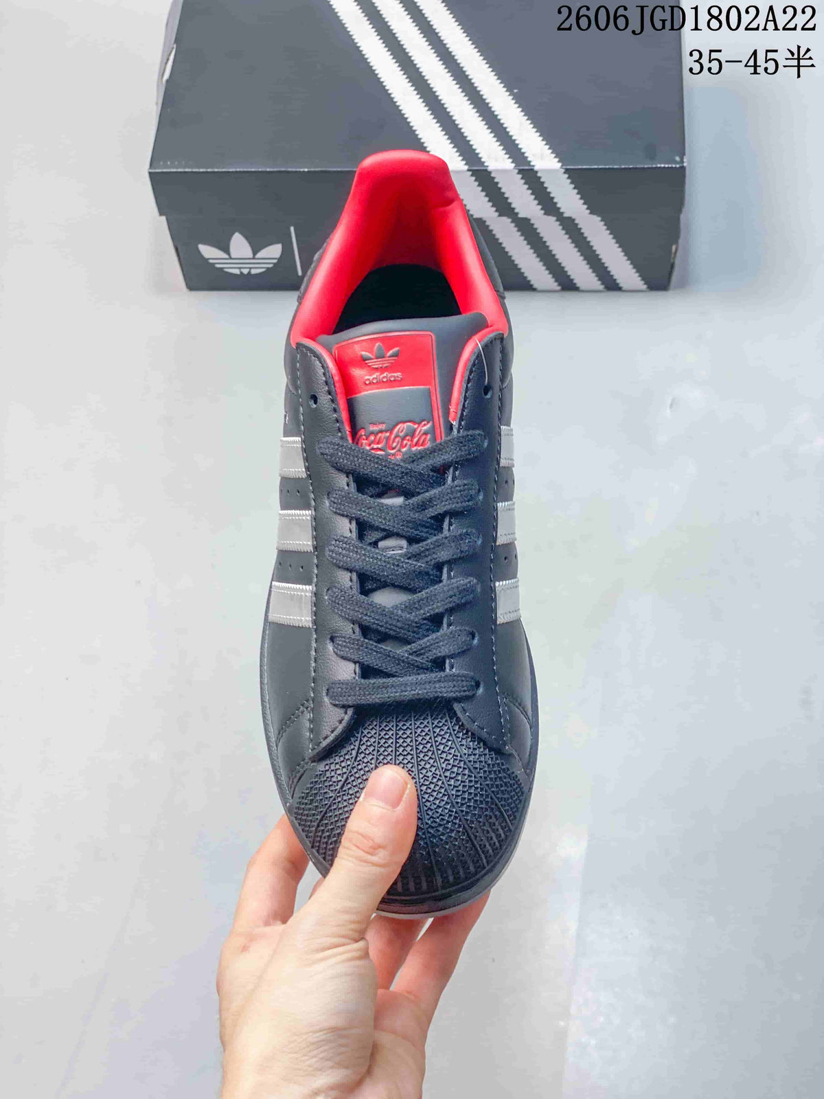 Front view of the sneaker showing its laces, textured shell toe, and red-lined collar.