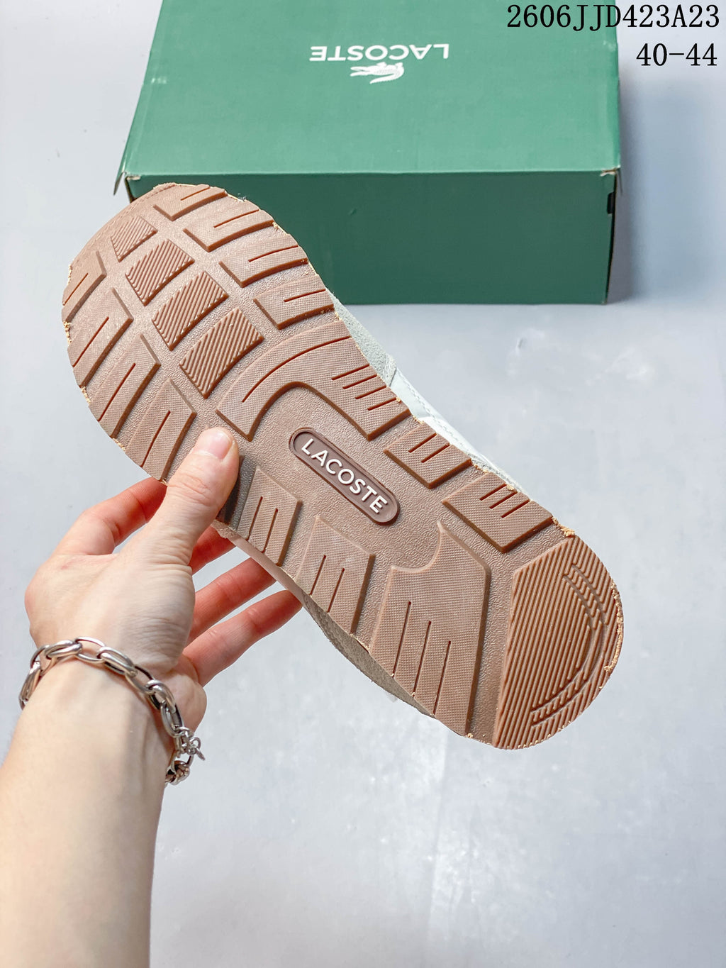 Underside of a Lacoste sneaker showing its patterned textured outsole.