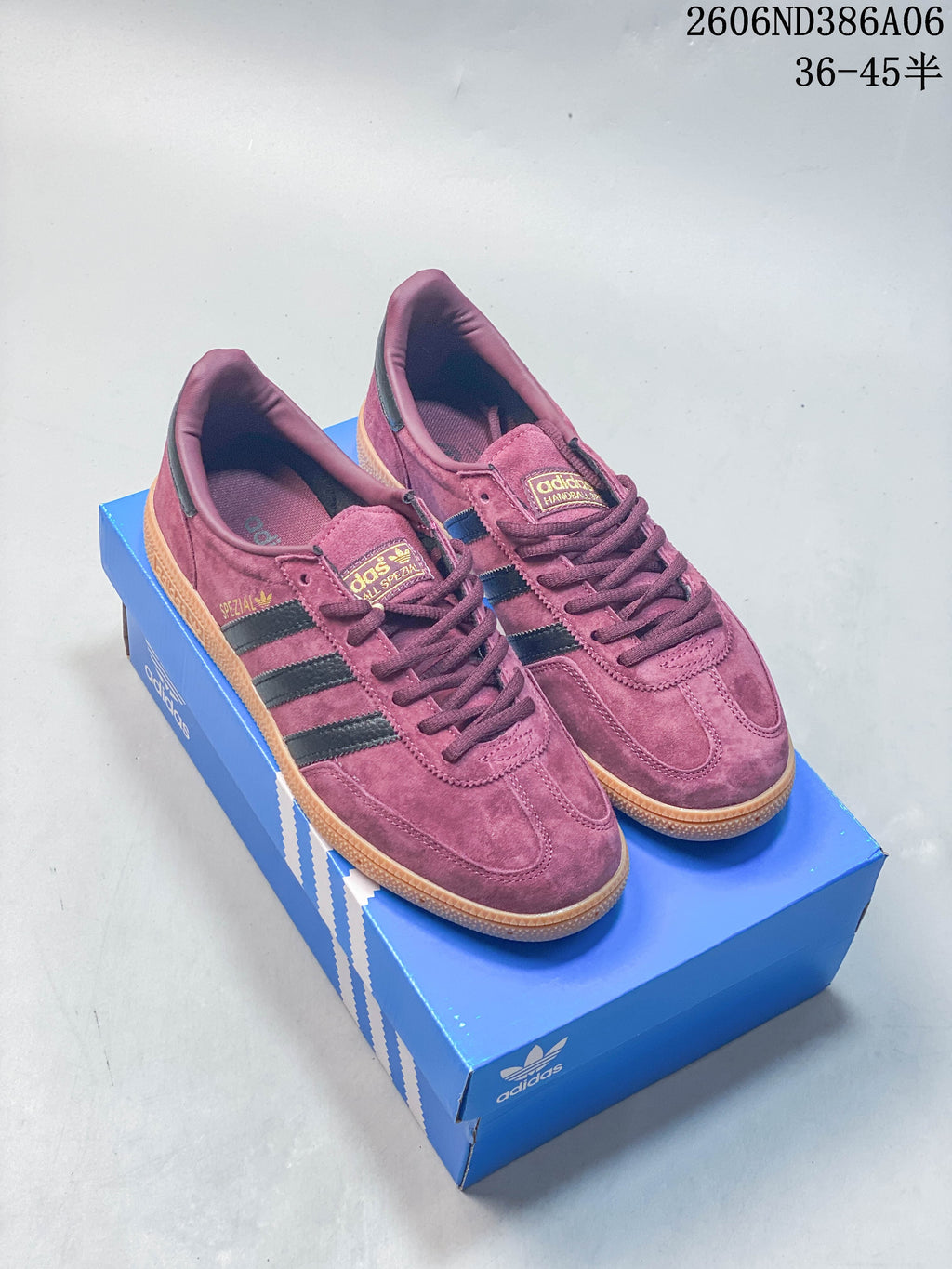 Burgundy Adidas Handball Spezial sneakers with three dark side stripes and gum-colored outsoles