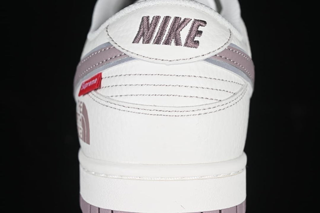 Rear view showing Nike branding and mauve heel accents