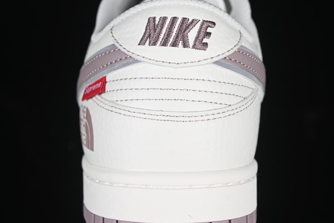 Rear view showing Nike branding and mauve heel accents